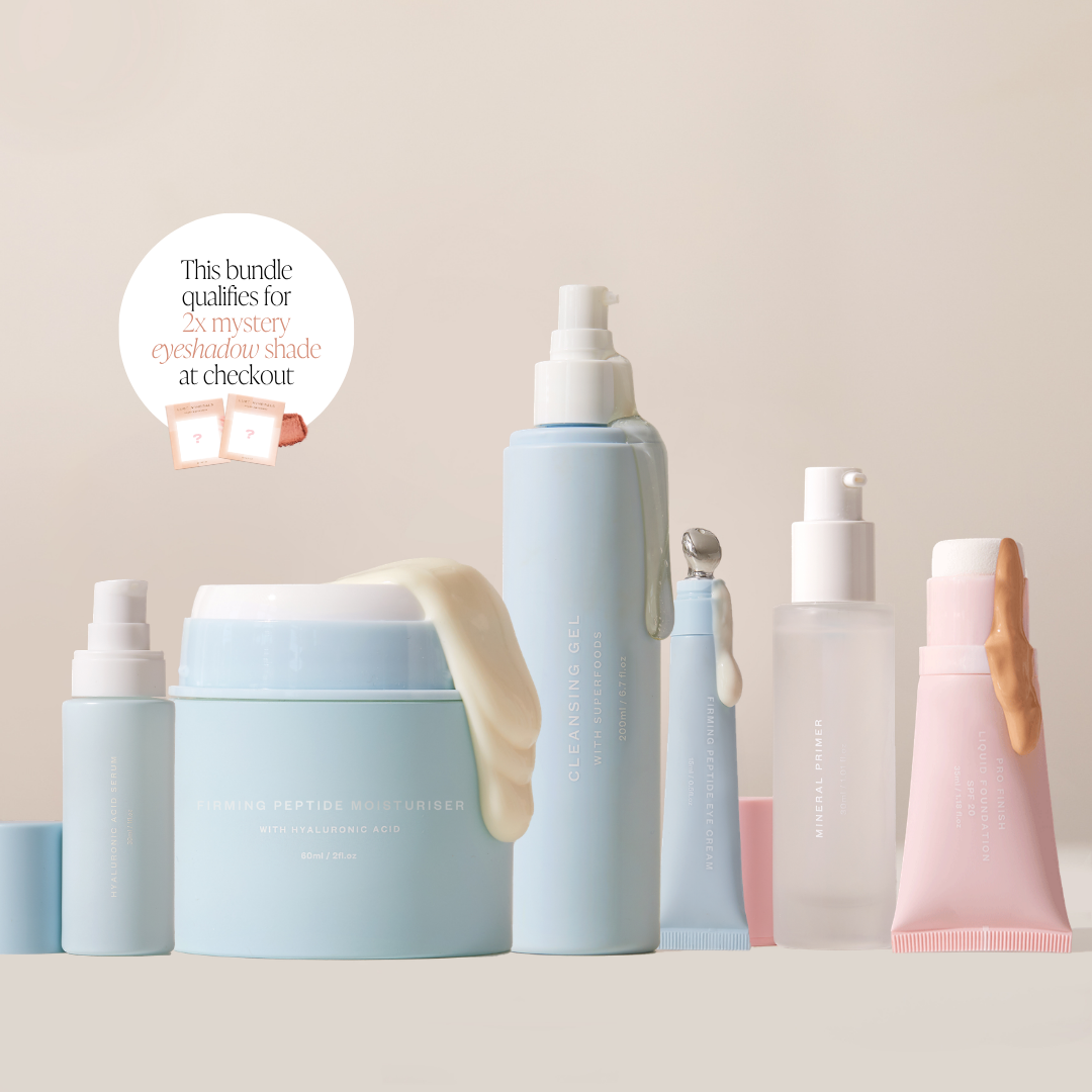 A skincare bundle featuring multiple cosmetic containers in soft pastel shades of light blue, pink, and white, arranged on a neutral beige background with a promotional badge.